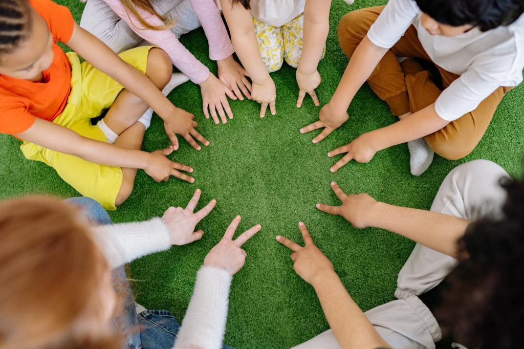 Kids sitting in a circle playing together.